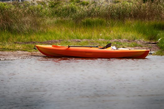 orange kayak on pamlino sound beach in north carolina