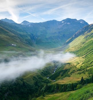 Composite of low hanging cloud in La Peule valley, Switzerland, with Percé Mountain in the background. The region is one of the stages in the popular Mont Blanc tour, which crosses three countries.