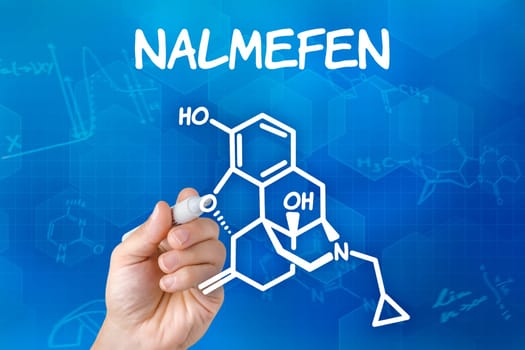 Hand with pen draws chemical structural formula of nalmefen