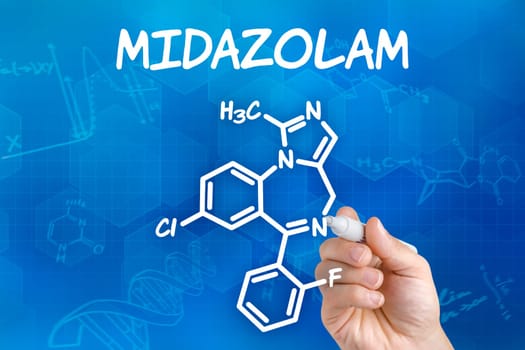 Hand with pen draws chemical structural formula of midazolam