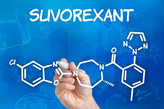Hand with pen draws chemical structural formula of Suvorexant