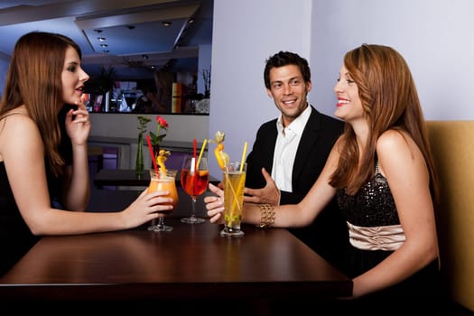 Group of friends together having fun. Focus on the man