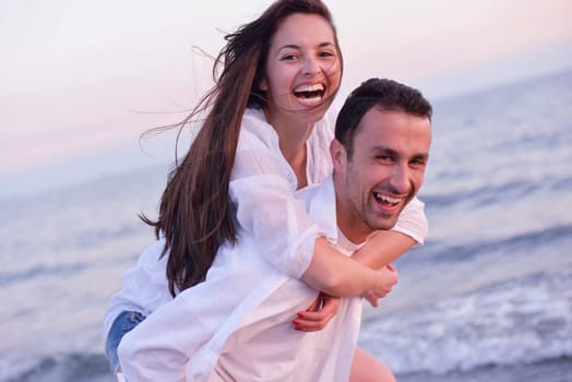 happy young romantic couple in love have fun on beautiful beach at beautiful summer day