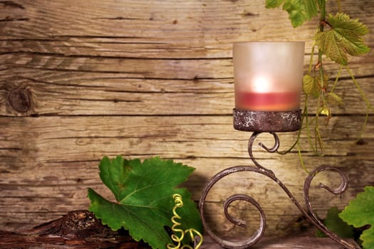 Candle holder with vine leaves