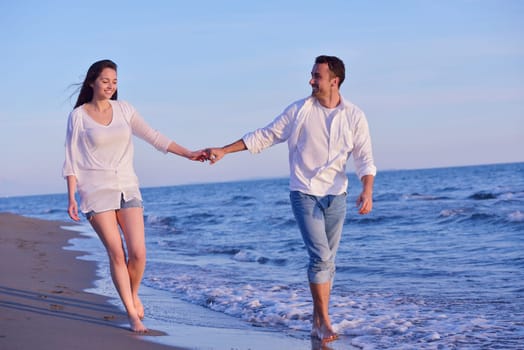 happy young romantic couple in love have fun on beautiful beach at beautiful summer day