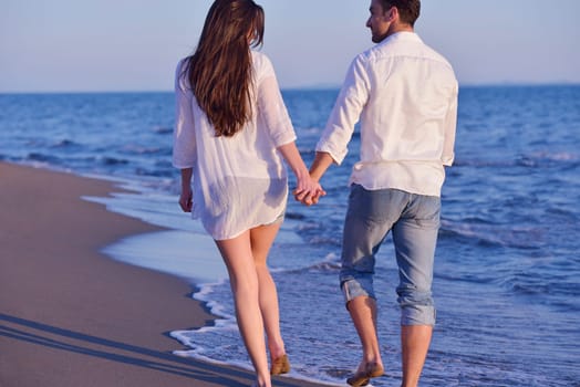 happy young romantic couple in love have fun on beautiful beach at beautiful summer day