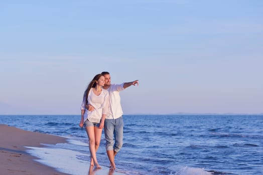happy young romantic couple in love have fun on beautiful beach at beautiful summer day