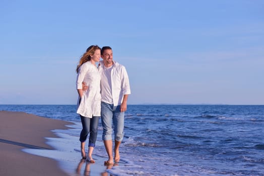 happy young romantic couple in love have fun on beautiful beach at beautiful summer day