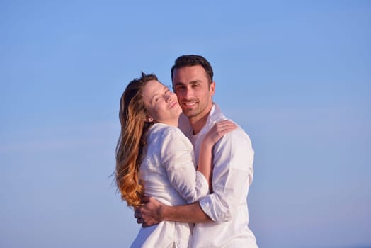happy young romantic couple in love have fun on beautiful beach at beautiful summer day