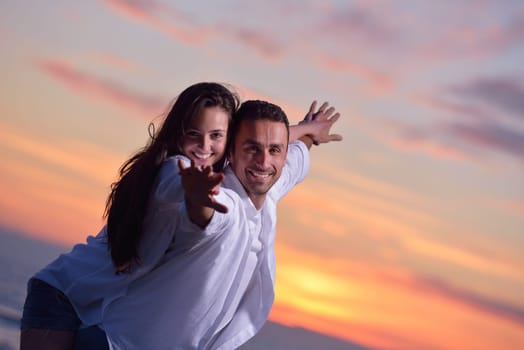 happy young romantic couple in love have fun on beautiful beach at beautiful summer day