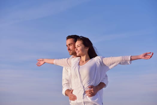 happy young romantic couple in love have fun on beautiful beach at beautiful summer day