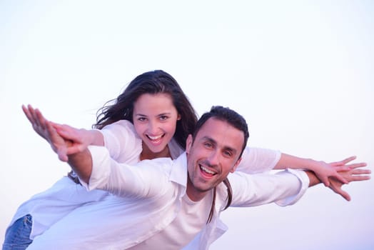 happy young romantic couple in love have fun on beautiful beach at beautiful summer day