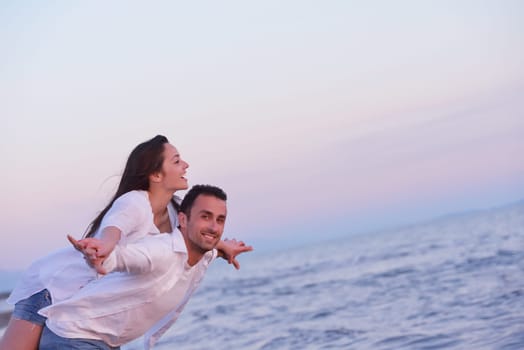 happy young romantic couple in love have fun on beautiful beach at beautiful summer day