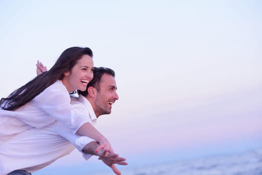happy young romantic couple in love have fun on beautiful beach at beautiful summer day
