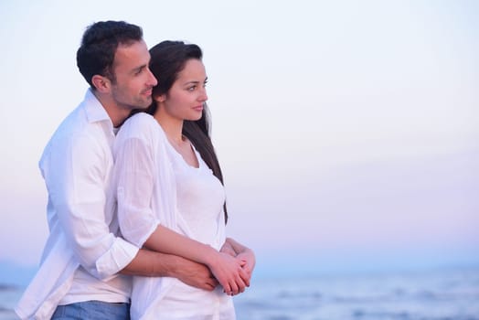 happy young romantic couple in love have fun on beautiful beach at beautiful summer day