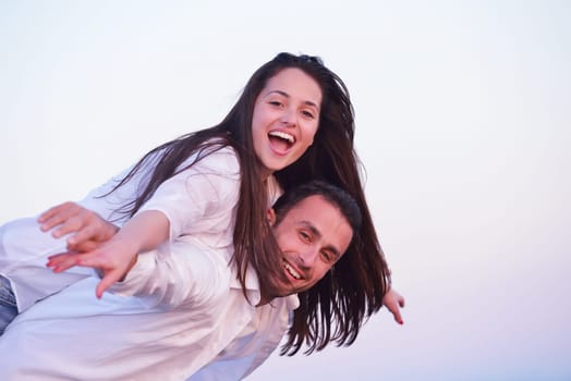 happy young romantic couple in love have fun on beautiful beach at beautiful summer day