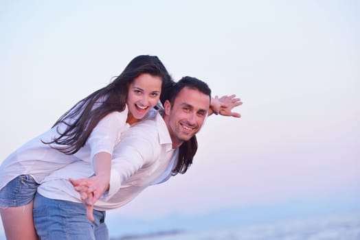 happy young romantic couple in love have fun on beautiful beach at beautiful summer day