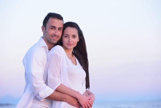 happy young romantic couple in love have fun on beautiful beach at beautiful summer day