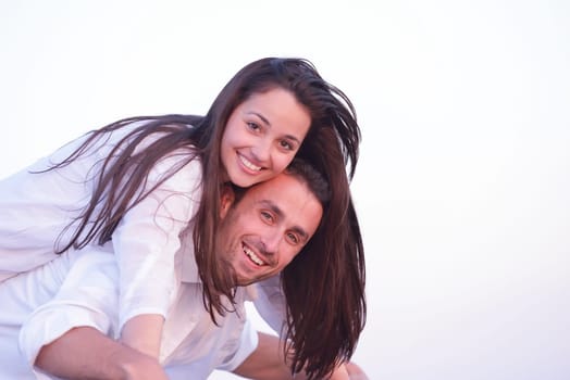 happy young romantic couple in love have fun on beautiful beach at beautiful summer day