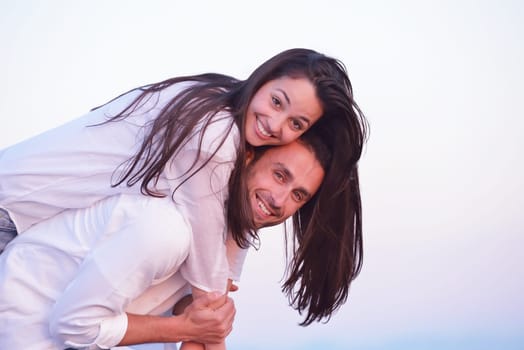 happy young romantic couple in love have fun on beautiful beach at beautiful summer day