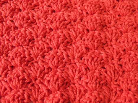Background of crocheted shell pattern in red