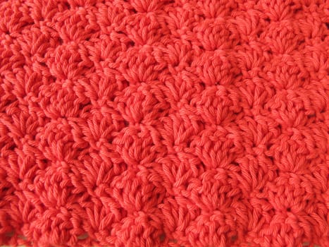 Background of crocheted shell pattern in red