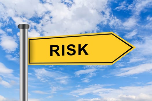 risk words on yellow road sign on blue sky