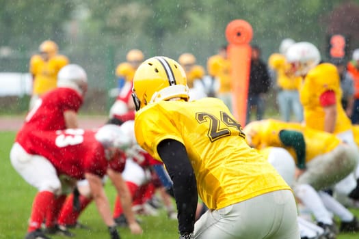 American football game in rain