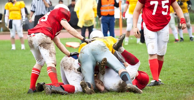 American football game in rain