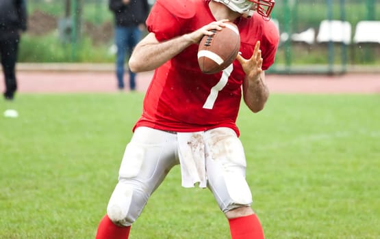 American football game in rain