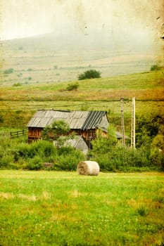 Old house in the mountains on the field