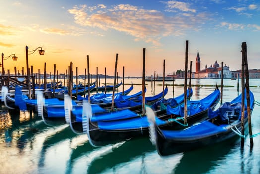 Gondolas moored by Saint Mark square with San Giorgio di Maggiore church in the background - Venice, Venezia, Italy, Europe