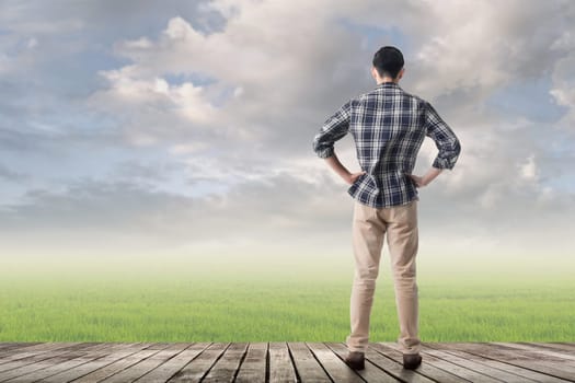Asian man against grassland with copyspace.