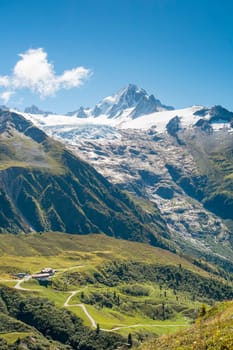 Chalets at the bottom of massive Tour Glaciers, in France.