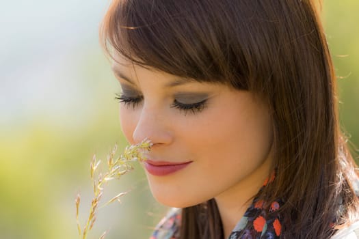 The young woman is enjoying the natural beauty. Wonderful picture with nice colors.