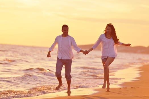 happy young romantic couple in love have fun on beautiful beach at beautiful summer day