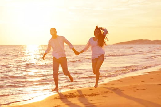happy young romantic couple in love have fun on beautiful beach at beautiful summer day