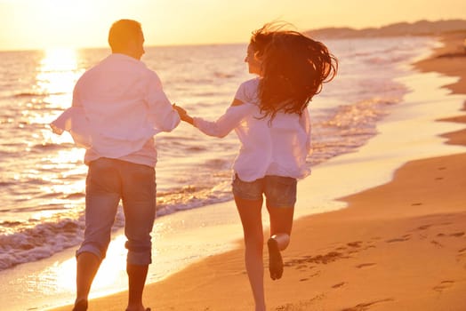 happy young romantic couple in love have fun on beautiful beach at beautiful summer day