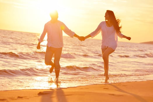 happy young romantic couple in love have fun on beautiful beach at beautiful summer day