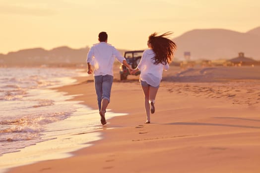 happy young romantic couple in love have fun on beautiful beach at beautiful summer day