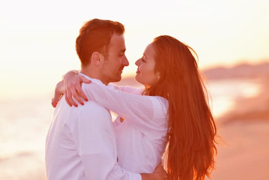 happy young romantic couple in love have fun on beautiful beach at beautiful summer day