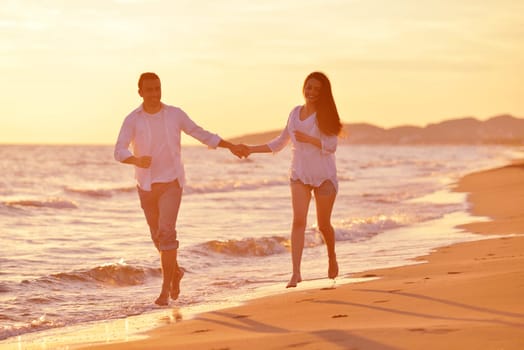 happy young romantic couple in love have fun on beautiful beach at beautiful summer day