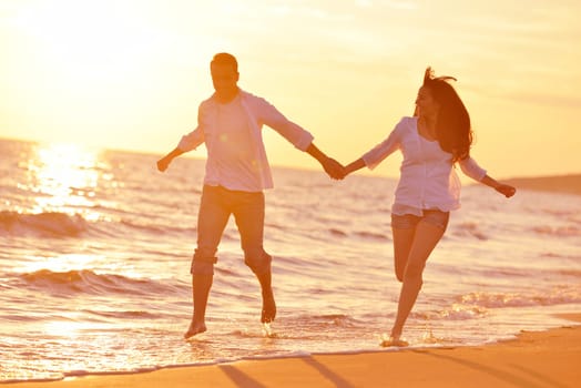 happy young romantic couple in love have fun on beautiful beach at beautiful summer day