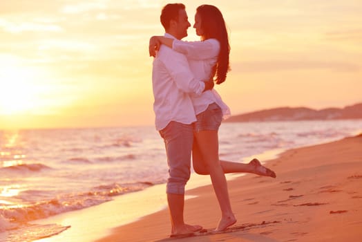 happy young romantic couple in love have fun on beautiful beach at beautiful summer day