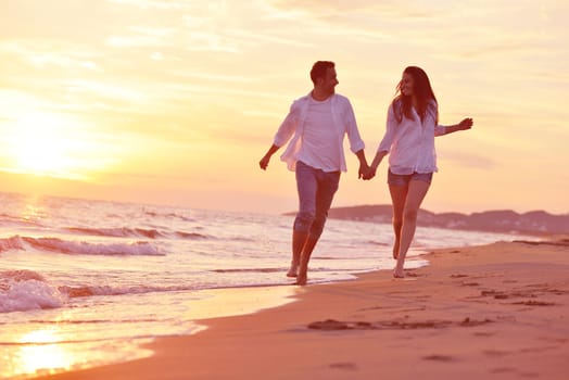 happy young romantic couple in love have fun on beautiful beach at beautiful summer day