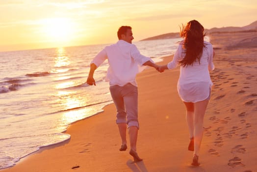 happy young romantic couple in love have fun on beautiful beach at beautiful summer day