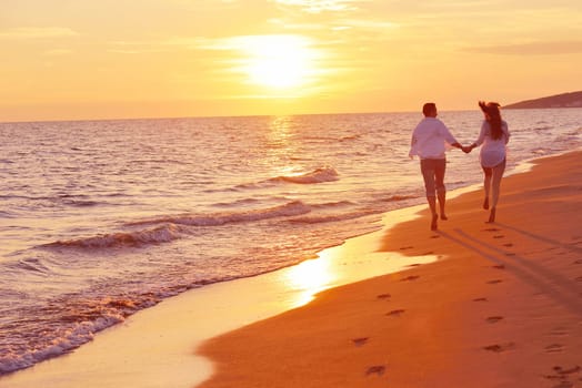 happy young romantic couple in love have fun on beautiful beach at beautiful summer day