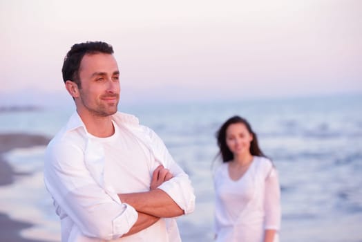 happy young romantic couple in love have fun on beautiful beach at beautiful summer day