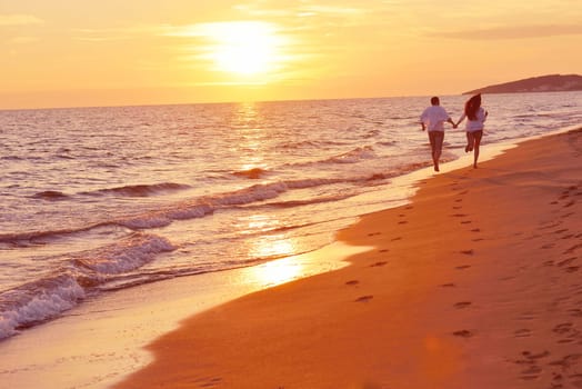 happy young romantic couple in love have fun on beautiful beach at beautiful summer day