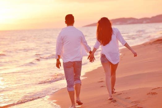 happy young romantic couple in love have fun on beautiful beach at beautiful summer day